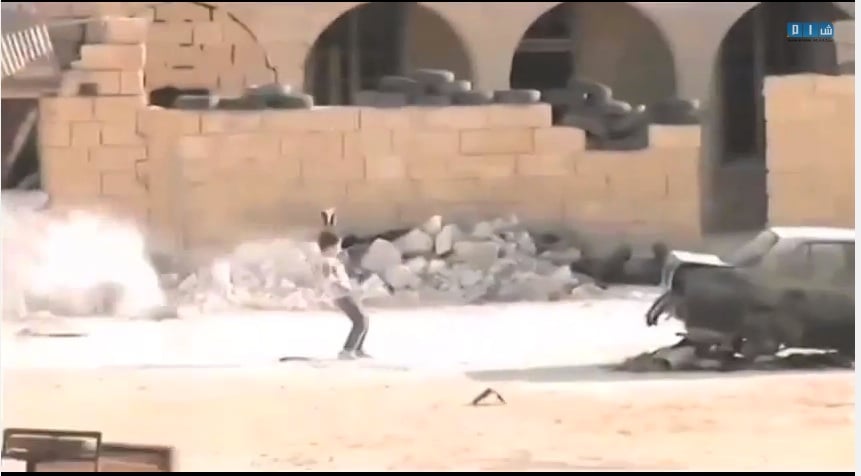 The boy faces heavy gun fire as he runs.