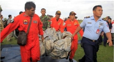A piece of the plane wreckage is recovered.