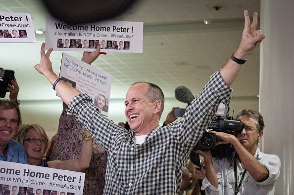Peter Greste (C) greets his supporters and the media after landing back in Australia at Brisbane Airport (Photo: Robert Shakespeare/Getty Images)