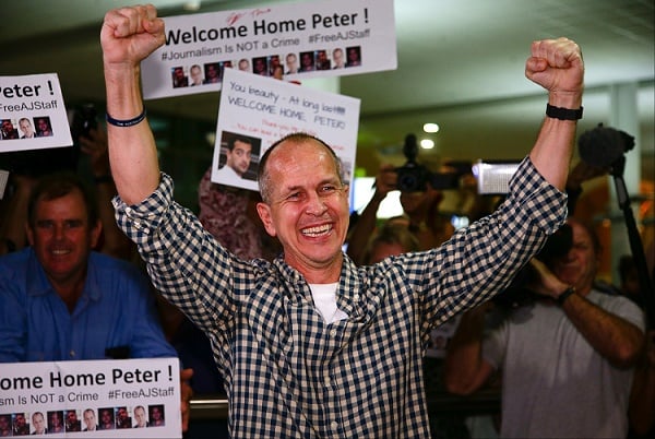 Al-Jazeera journalist Peter Greste punches the air upon his arrival at Brisbane's international airport in the early hours of February 5, 2015.  (Photo: PATRICK HAMILTON/AFP/Getty Images)