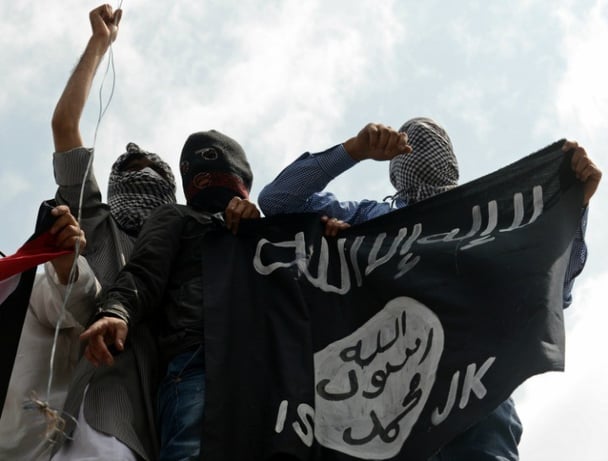 Young men fly the ISIS flag. 