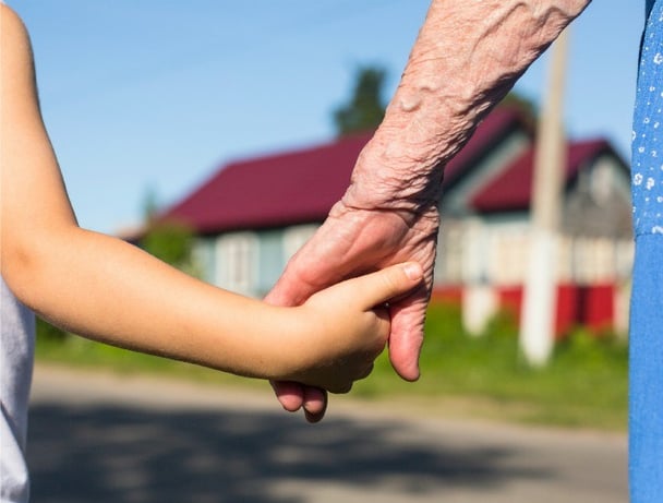 Hands of the old woman and child.
