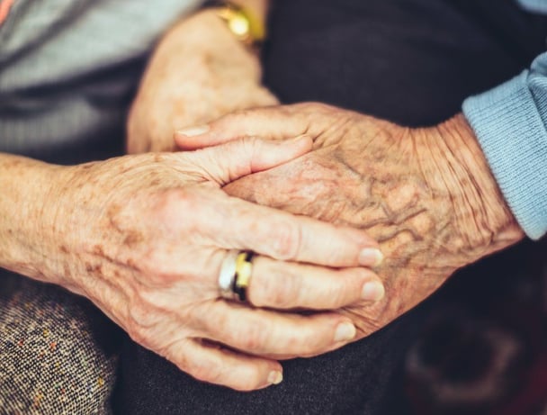old people holding hands