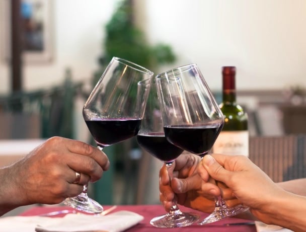 Group of friend clinking glasses of wine in a restaurant