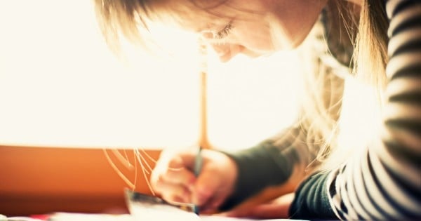 woman writing in sunlight