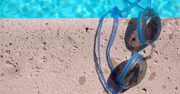 Goggles on the side of the pool
