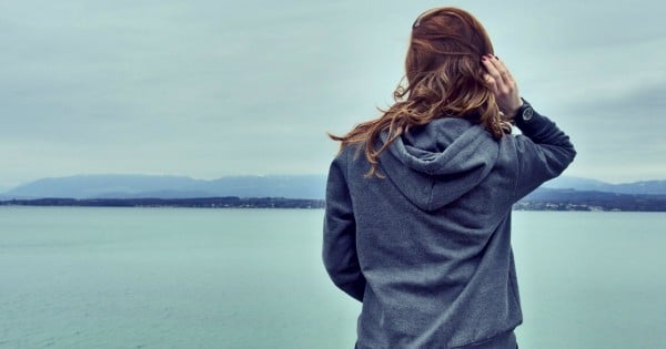 woman sad lake