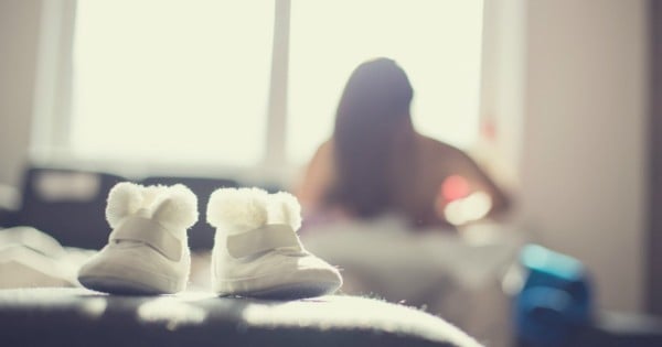 Young mother breastfeeding her little baby, defocused
