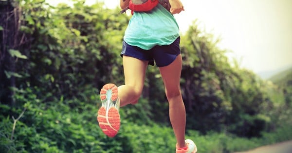 trail runner athlete running on forest trail. woman fitness jogging workout wellness concept.