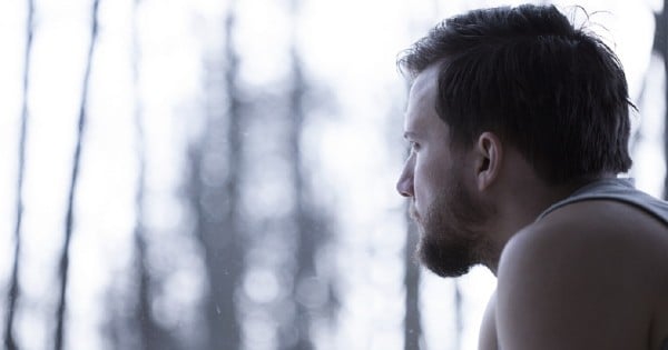 Man observing the view outside the window