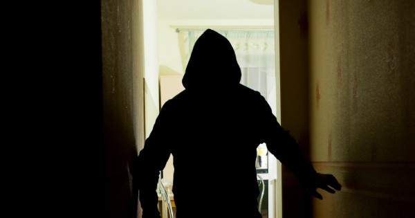 A murderer man creeps in the dark with a knife