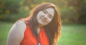 Close up of happy fatty asian woman outdoor in a park