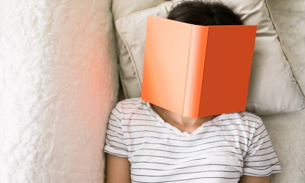 girl with book sleeping
