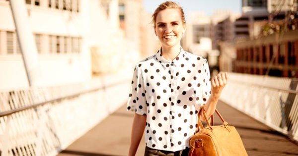 woman walking in city sunshine