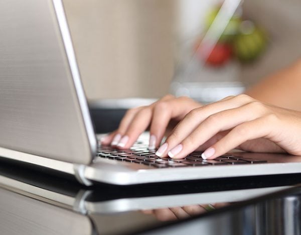 woman typing on laptop