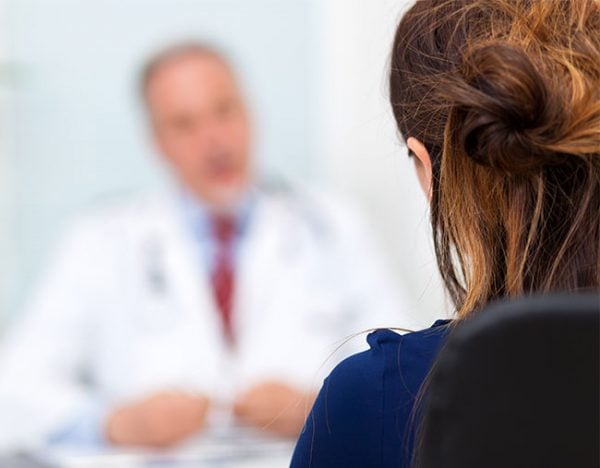 woman speaking to doctor GP