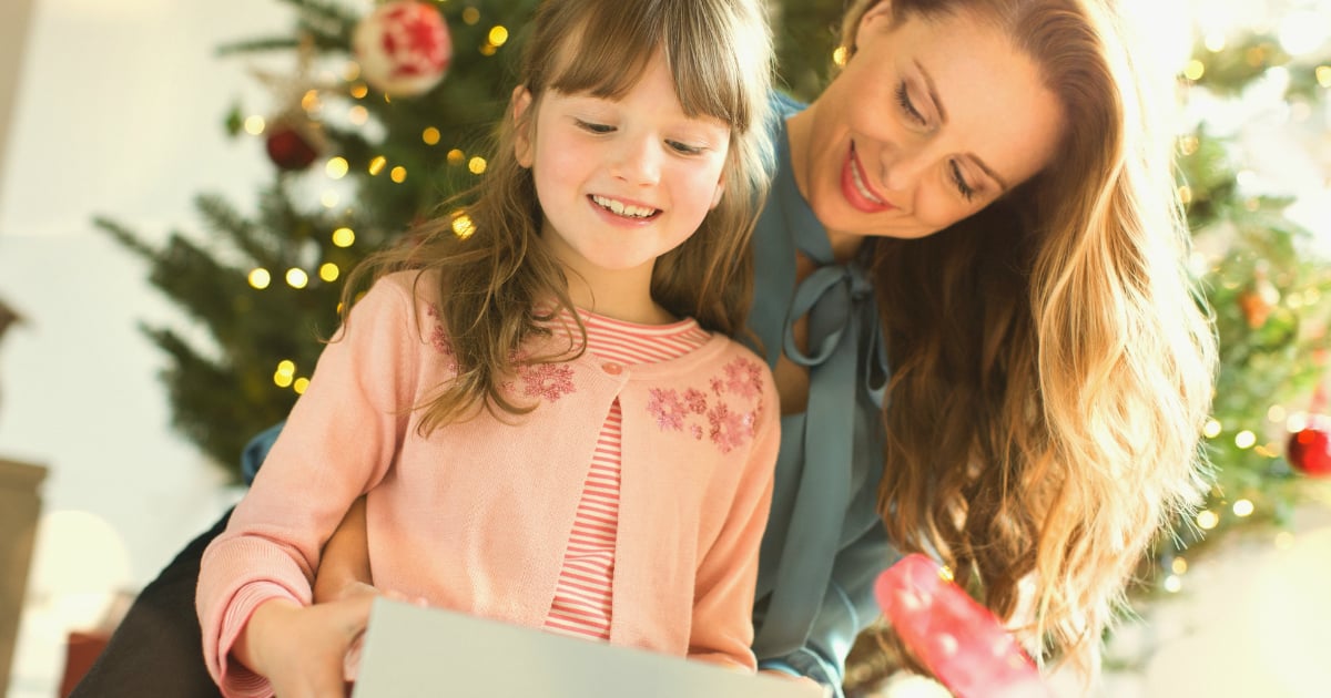 Mother daughter Christmas. Daughter watches mom