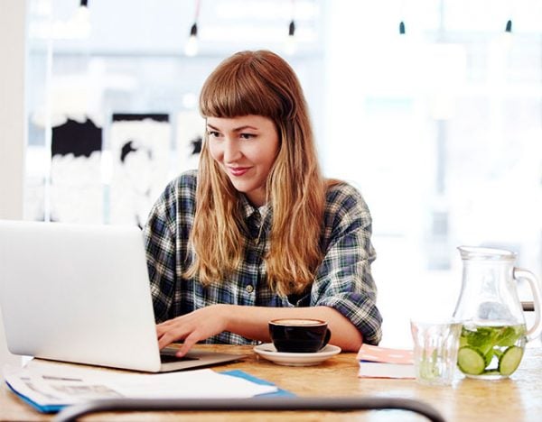 woman sending email smiling laptop computer