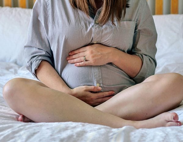 pregnant woman holding belly