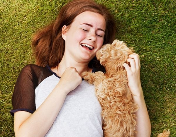 woman cuddling dog pet puppy happy
