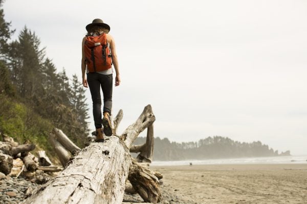 Woman walking along log