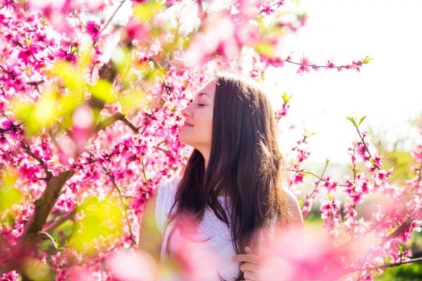Woman walking through flowers