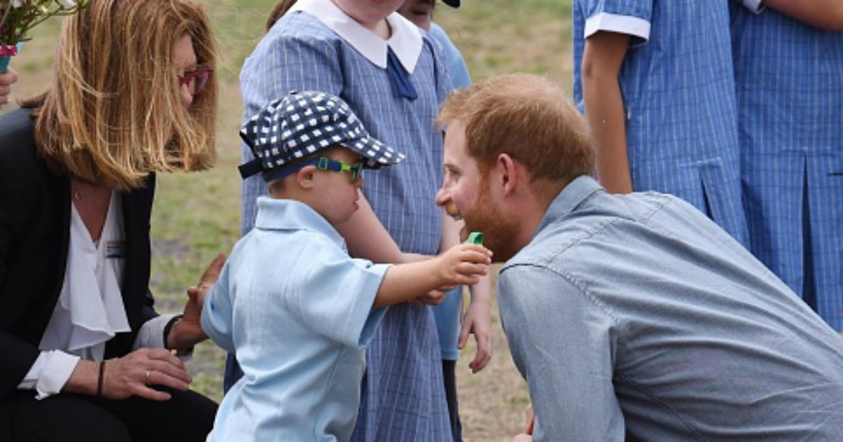 Why we need to look at the woman in this photo of Prince Harry.