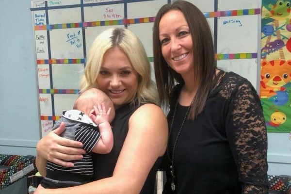 baby carried by two mothers