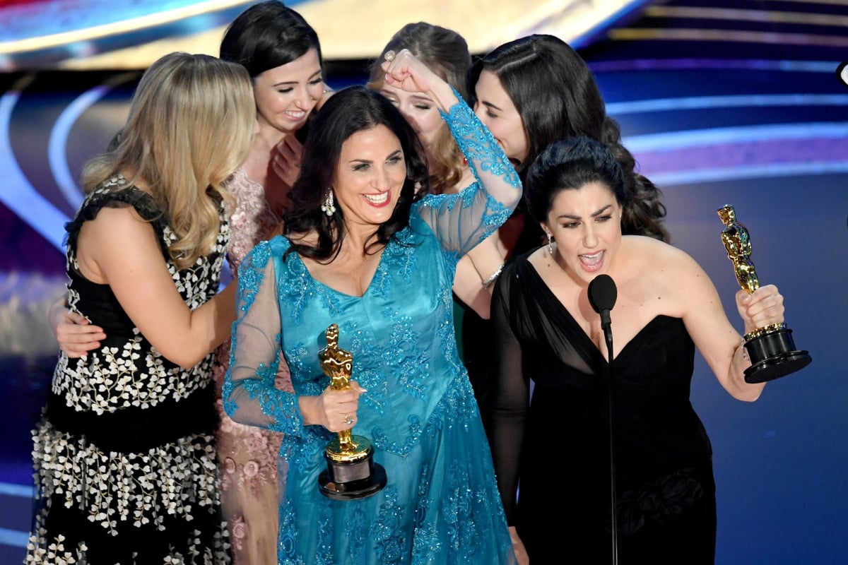 Melissa Berton (center L) and Rayka Zehtabchi (center R) accept their Oscar for Period.