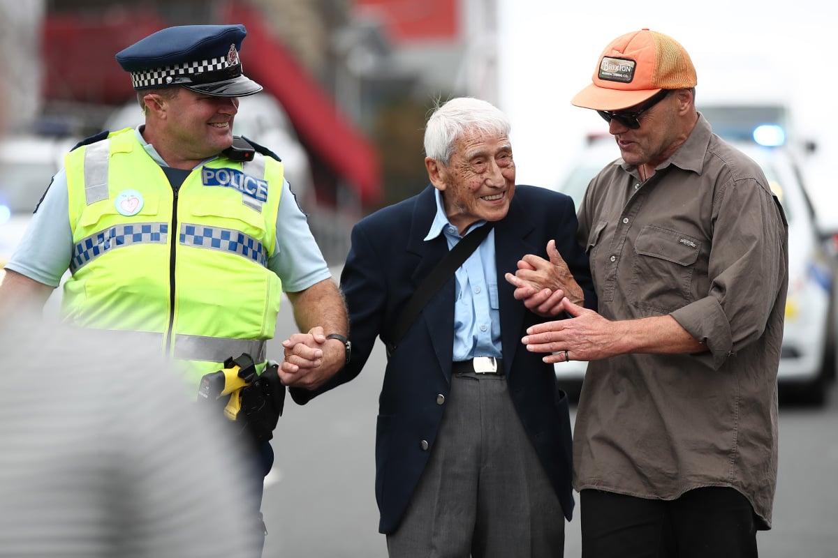 Auckland policeman Rob, John Sato and actor Bruce Hopkins walk the Love Aotearoa Hate Racism march