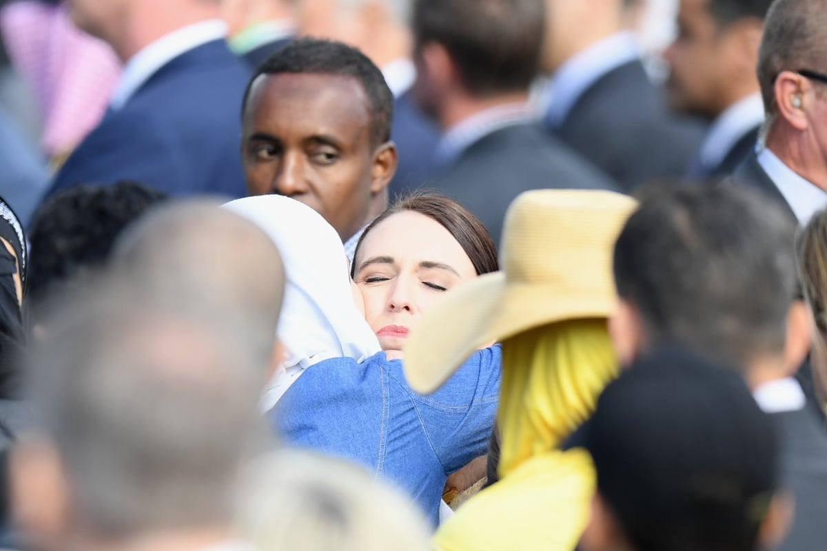 New Zealand Prime Minister Jacinda Ardern embraces a member of the Muslim community at the end of the National Remembrance Service.