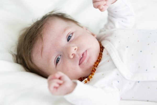 3 month old beautiful, cute baby with amber necklace
